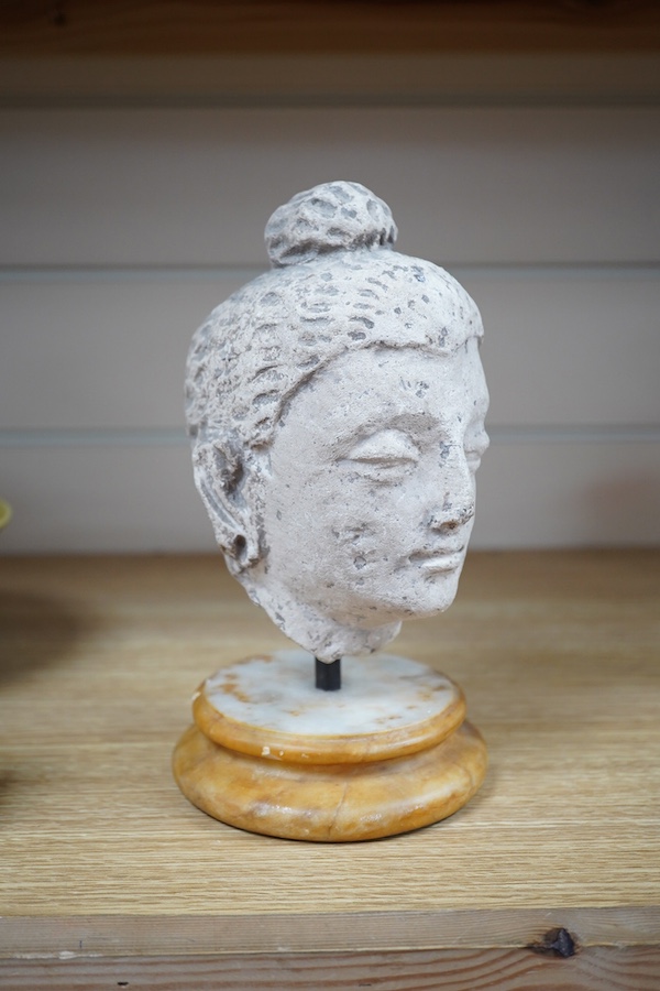 A stucco work head of Buddha, on marble stand, 21cm. Condition - fair